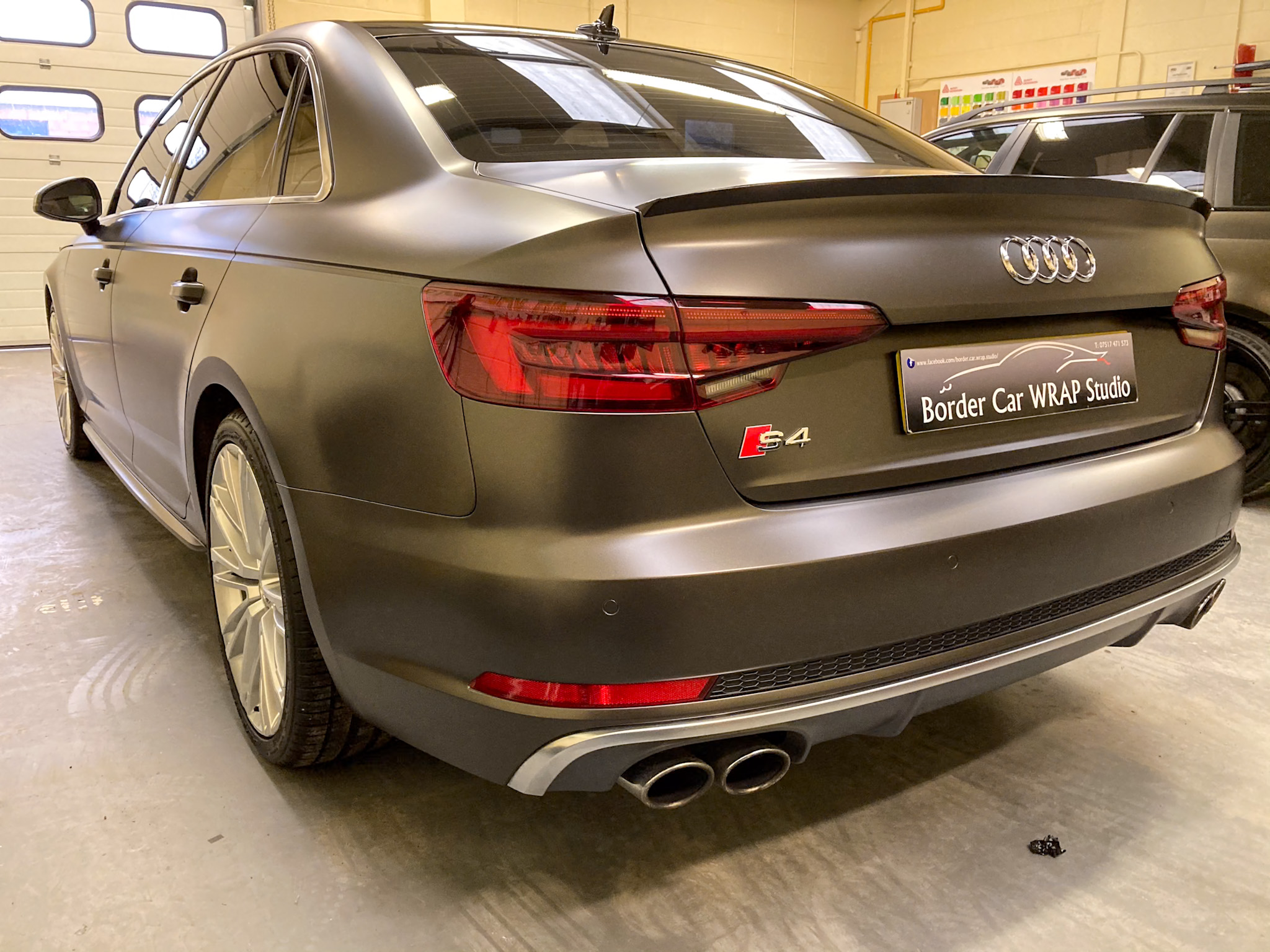 Car wrapping service illustrating the application process of a vehicle wrap to enhance and protect the car's appearance.